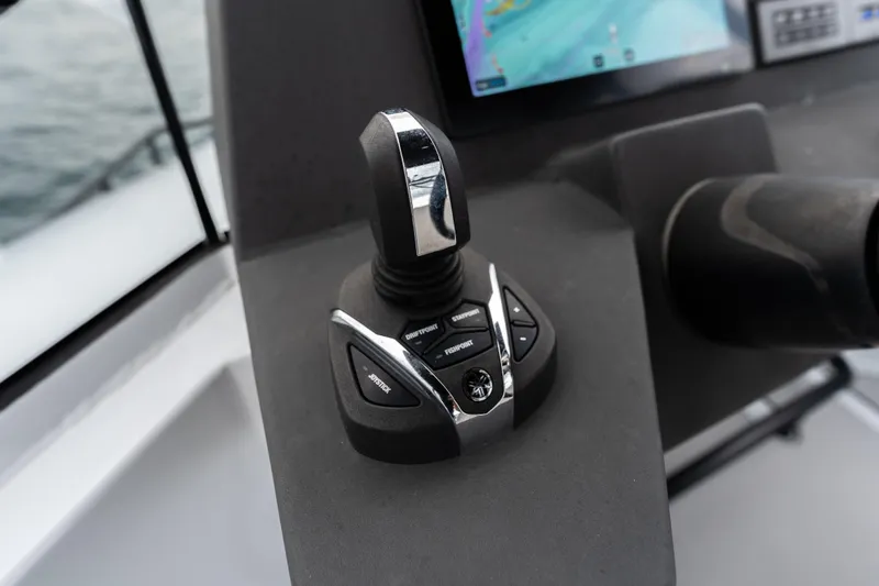 Slide: The Image of Joystick control on 2023 Vandal 46 Explorer boat dashboard with navigation screen. - 21