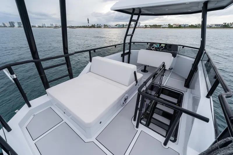 Slide: The Image of 2023 Vandal 46 Explorer yacht interior with seating, railing, and ocean view. - 25
