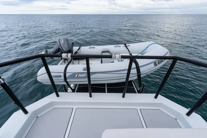 Slide: The Image of 2023 Vandal 46 Explorer yacht with inflatable boat on deck, ocean view. - 27