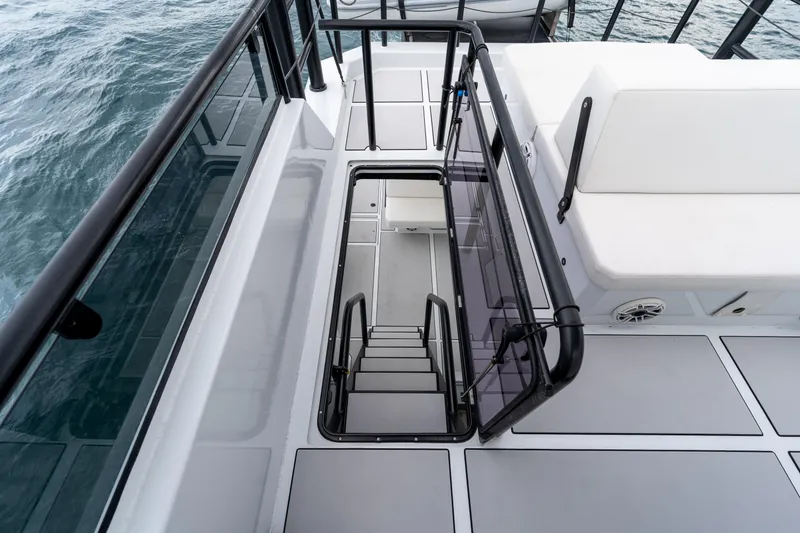 Slide: The Image of 2023 Vandal 46 Explorer yacht deck with stairs and seating, overlooking the ocean. - 29