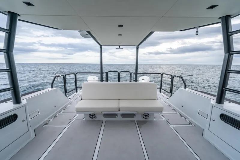 Slide: The Image of 2023 Vandal 46 Explorer boat interior with ocean view, featuring sleek seating and modern design. - 30