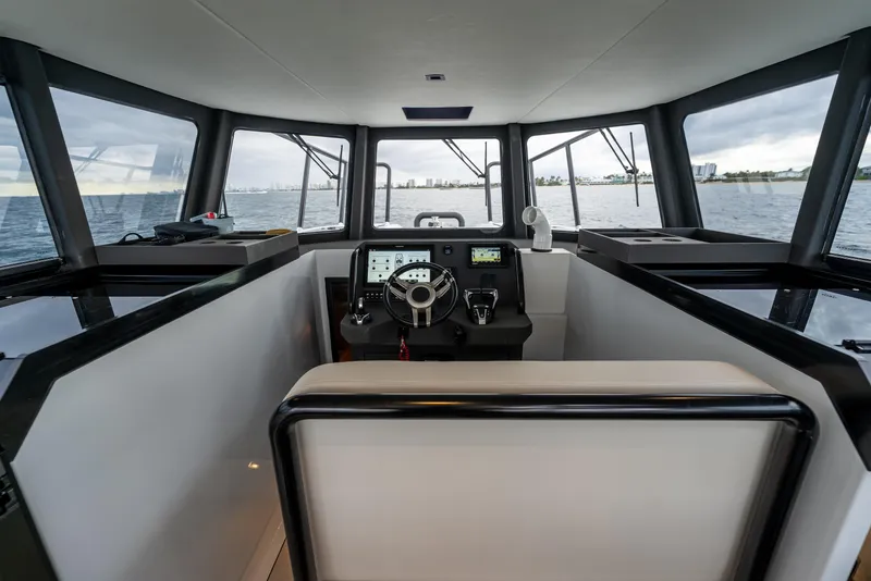 Slide: The Image of Interior view of 2023 Vandal 46 Explorer yacht cockpit with modern controls and panoramic windows. - 41
