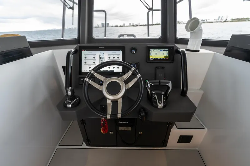 Slide: The Image of 2023 Vandal 46 Explorer cockpit with modern navigation controls and steering wheel. - 42