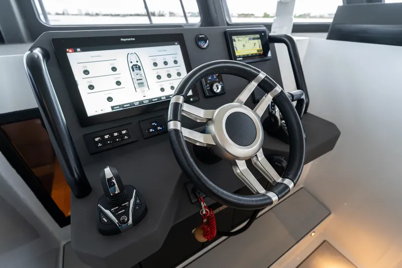 Slide: The Image of Helm of 2023 Vandal 46 Explorer with advanced navigation controls and touchscreen display. - 43