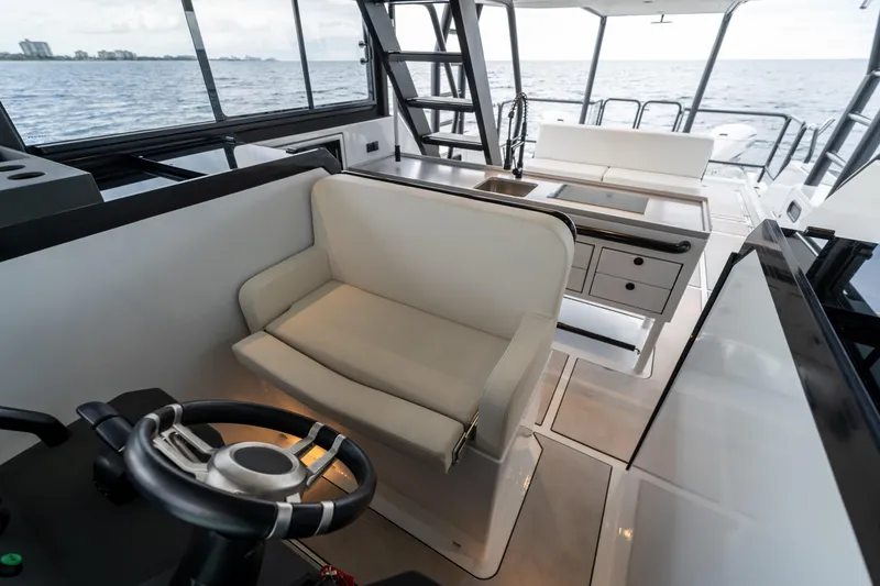 Slide: The Image of Interior of 2023 Vandal 46 Explorer yacht with helm, seating, and ocean view. - 46