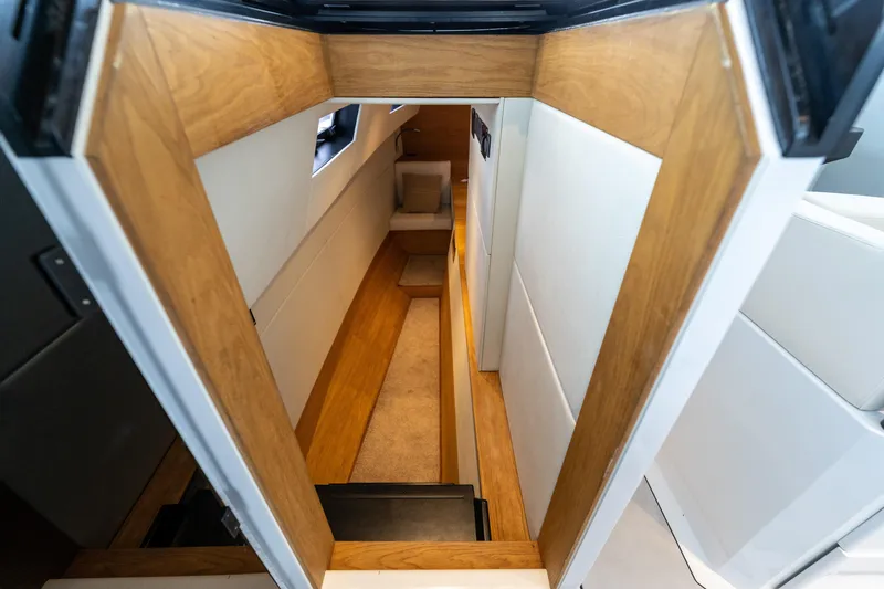 Slide: The Image of Interior view of 2023 Vandal 46 Explorer yacht, featuring sleek wooden and white paneling. - 47
