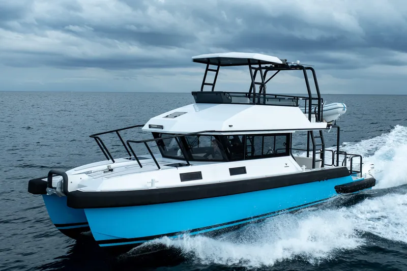 Slide: The Image of 2023 Vandal 46 Explorer yacht cruising on open sea under cloudy skies. - 5