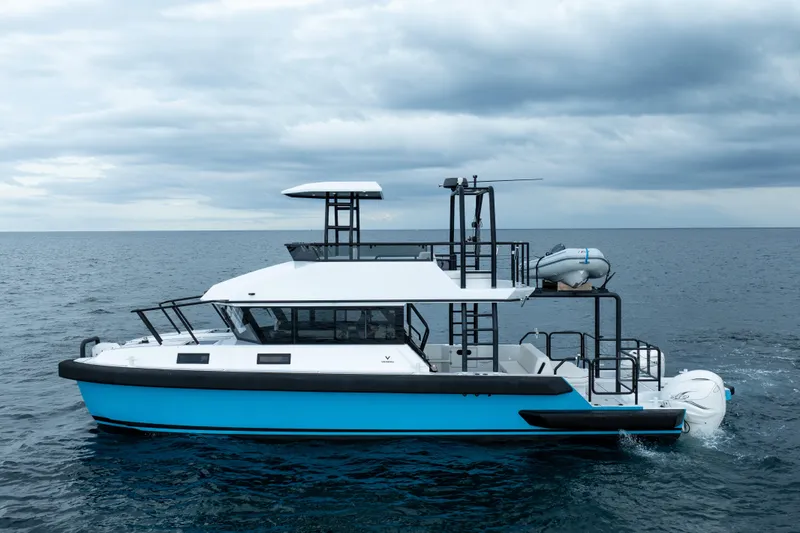 Slide: The Image of 2023 Vandal 46 Explorer yacht cruising on open sea under cloudy skies. - 8