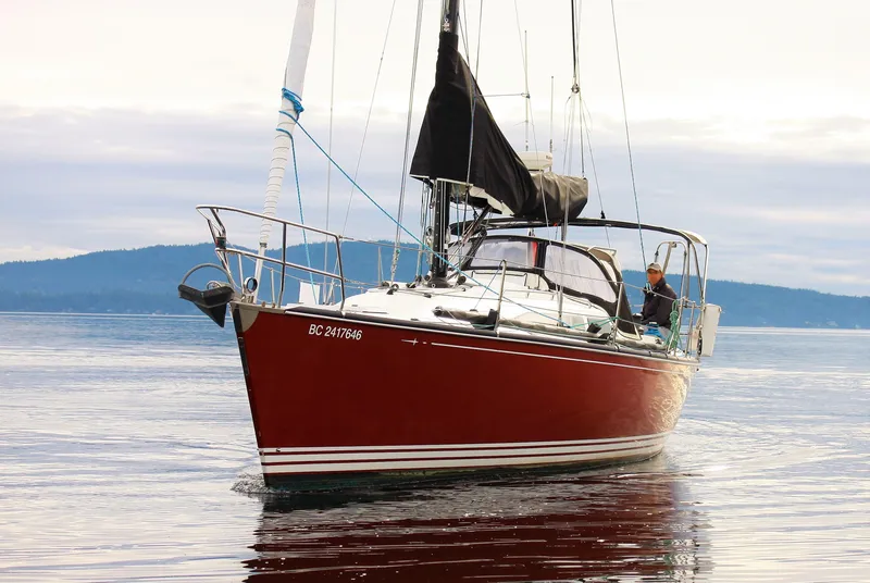 Slide: The Image of Red C&C 110 sailboat from 2005 on calm water. - 1
