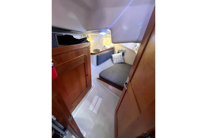 Slide: The Image of Cozy cabin interior of 2005 C&C 110 sailboat with wooden finishes and bedding. - 12