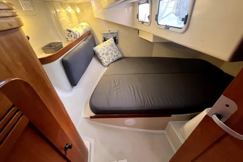 Slide: The Image of Cozy cabin interior of 2005 C&C 110 sailboat with comfortable bedding and soft lighting. - 13