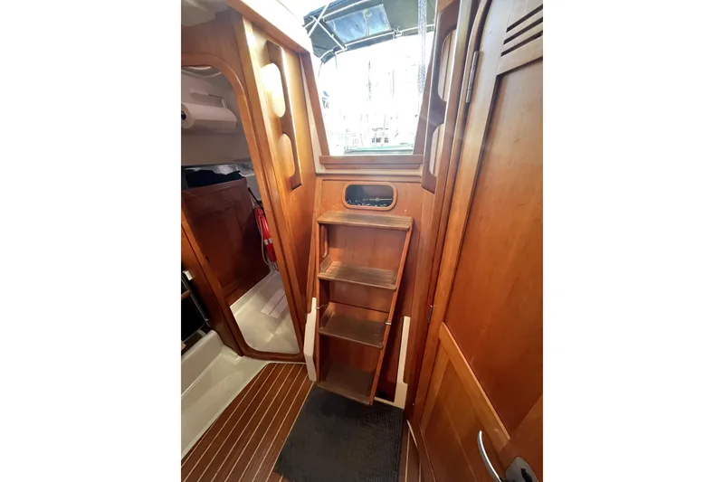 Slide: The Image of Interior of 2005 C&C 110 sailboat with wooden steps and cabinetry. - 16