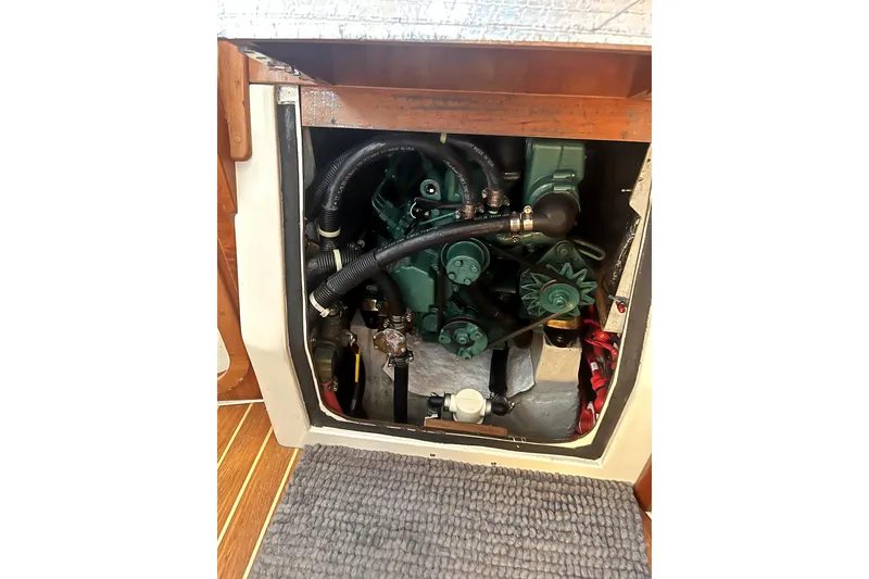 Slide: The Image of Engine compartment of a 2005 C&C 110 sailboat, showcasing mechanical components and hoses. - 17