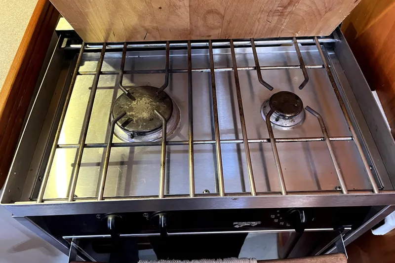 Slide: The Image of Two-burner stainless steel stove, C&C 110 model, 2005, with metal grates and control knobs. - 18