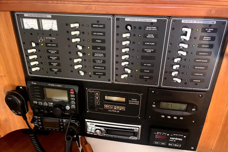 Slide: The Image of Electrical control panel on a 2005 C&C 110 yacht, featuring various switches and gauges. - 20