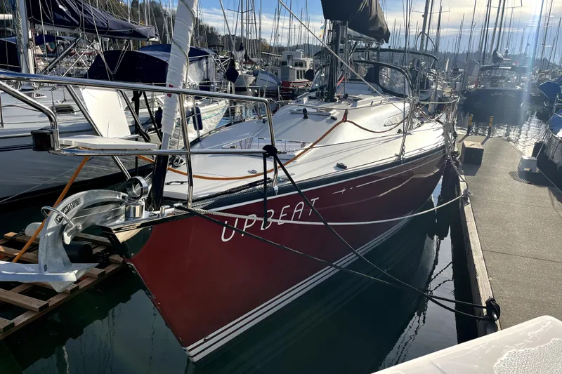 Slide: The Image of Sailboat "Upbeat" docked, C&C 110 model, 2005, in a marina under clear skies. - 21