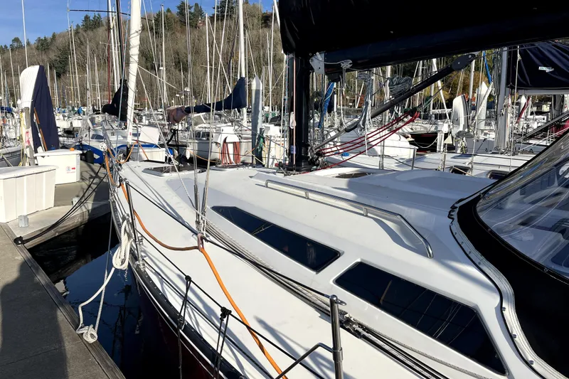 Slide: The Image of Docked 2005 C&C 110 sailboat surrounded by other vessels in a marina. - 23