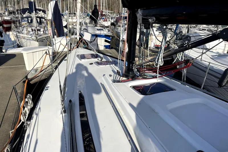 Slide: The Image of Sailboat docked at marina, C&C 110 model, 2005, with visible rigging and shadow. - 25