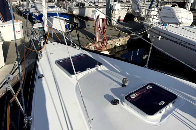 Slide: The Image of Sailboat deck view at marina, featuring C&C 110 model, 2005. - 27