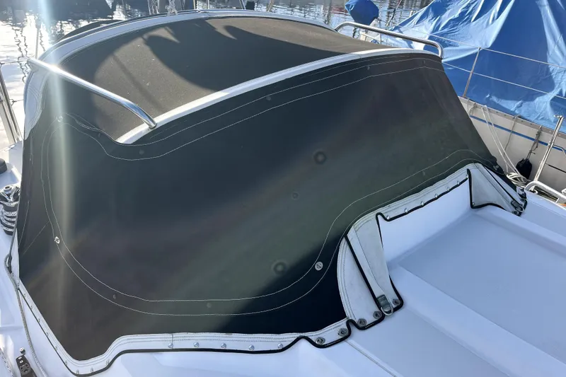 Slide: The Image of Boat cover on a 2005 C&C 110 sailboat, docked with sunlight reflections. - 33