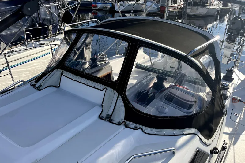 Slide: The Image of Sailboat cockpit of 2005 C&C 110 model, featuring sleek design and marina background. - 34