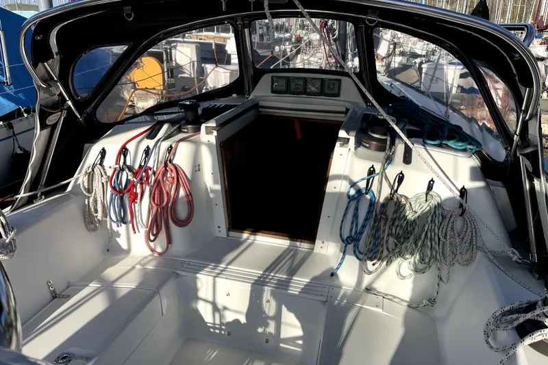Slide: The Image of Cockpit of a 2005 C&C 110 sailboat with neatly arranged ropes and equipment. - 37