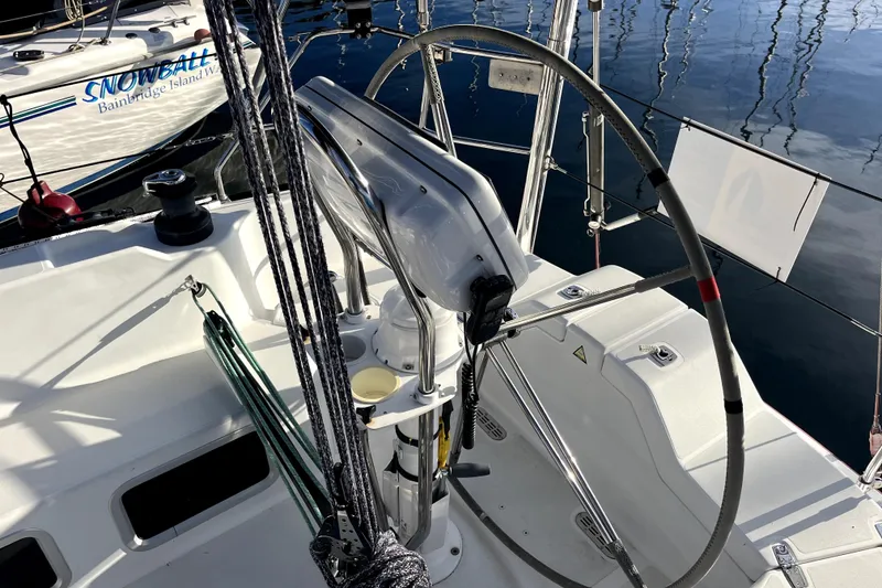 Slide: The Image of Steering wheel of a 2005 C&C 110 sailboat docked at a marina. - 43