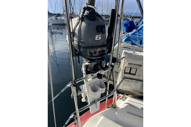 Slide: The Image of Boat with outboard motor and lifesling, docked in marina; C&C 110, 2005 model. - 48