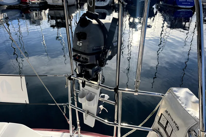Slide: The Image of Outboard motor on a 2005 C&C 110 sailboat, docked in a marina. - 49