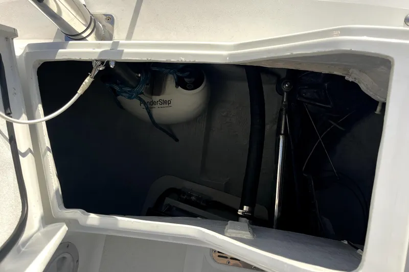 Slide: The Image of Open compartment of a 2005 C&C 110 sailboat, showing interior equipment and cables. - 51