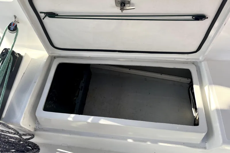 Slide: The Image of Open storage compartment on a 2005 C&C 110 boat, featuring ropes and a latch. - 52