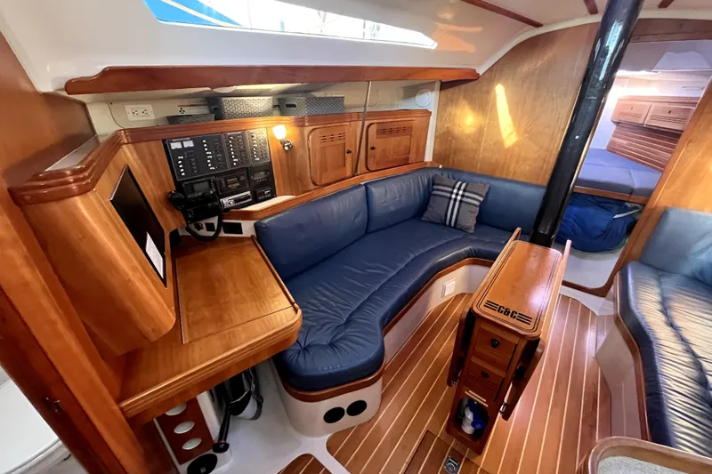 Slide: The Image of Luxurious 2005 C&C 110 yacht interior with blue seating and wooden finishes. - 8