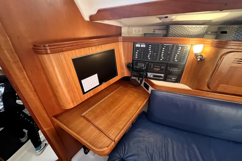 Slide: The Image of Navigation station in a 2005 C&C 110 sailboat with control panels and seating. - 9