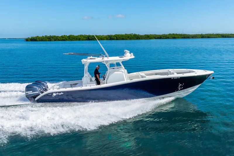 Slide: The Image of 2016 Yellowfin 36 Offshore boat cruising on clear blue water. - 1