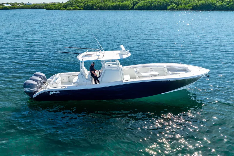 Slide: The Image of 2016 Yellowfin 36 Offshore boat on calm water, featuring triple Yamaha engines. - 10