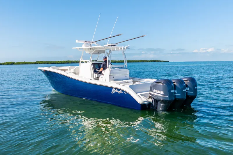 Slide: The Image of 2016 Yellowfin 36 Offshore boat with triple Yamaha engines on calm water. - 12