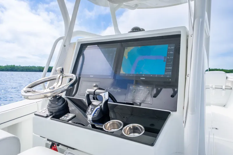 Slide: The Image of 2016 Yellowfin 36 Offshore boat dashboard with navigation screens and steering wheel. - 18