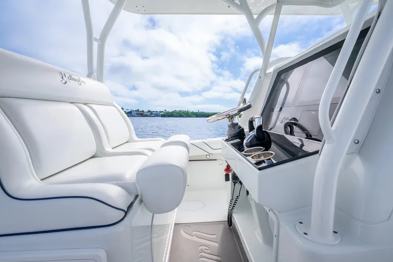 Slide: The Image of 2016 Yellowfin 36 Offshore boat interior with white seating and modern helm. - 21