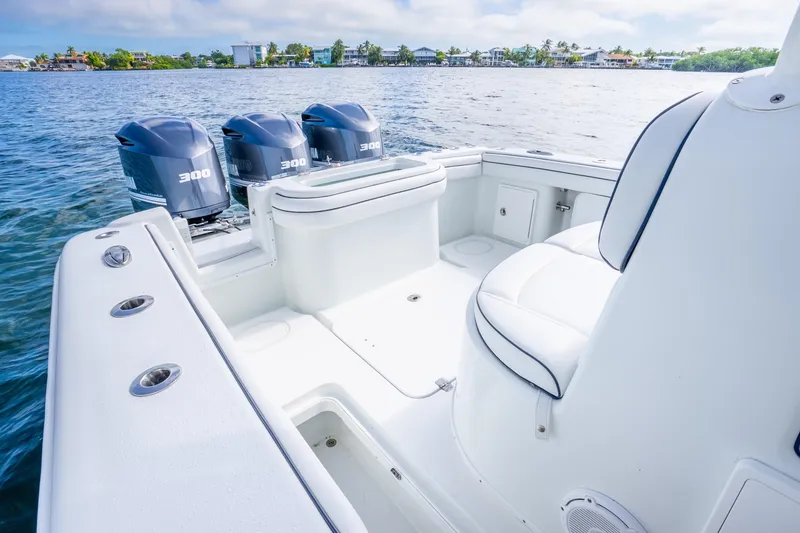 Slide: The Image of 2016 Yellowfin 36 Offshore boat with triple 300 horsepower engines on calm water. - 26