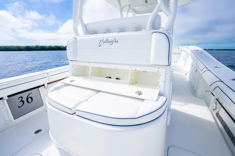 Slide: The Image of 2016 Yellowfin 36 Offshore boat interior with seating and storage, on calm water. - 27