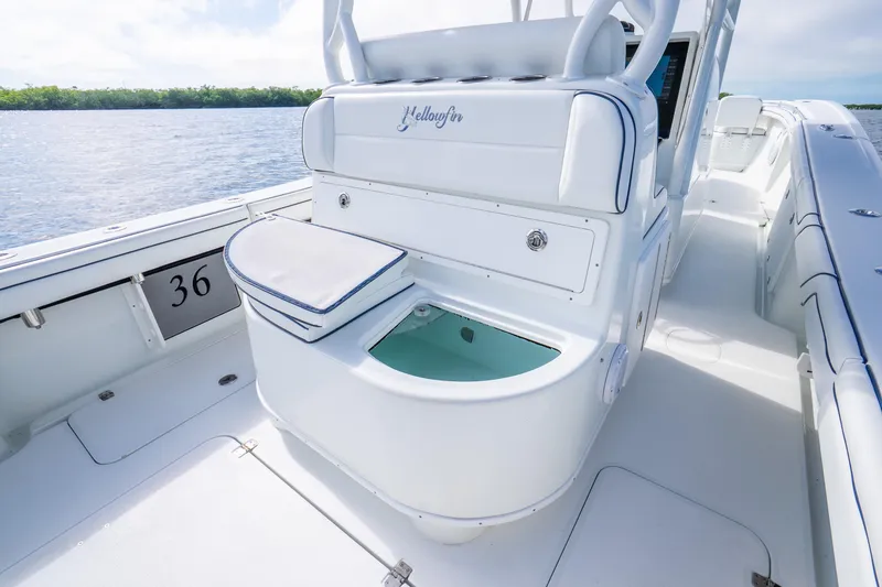Slide: The Image of 2016 Yellowfin 36 Offshore boat interior with seating and storage, on calm water. - 28