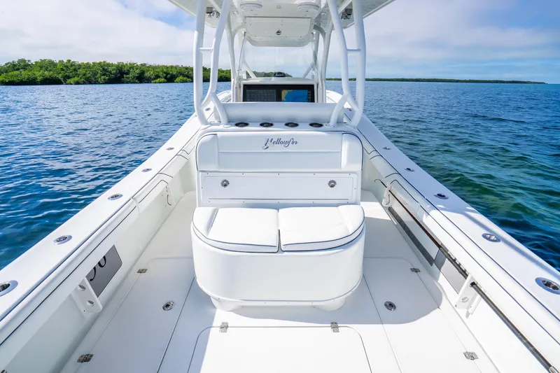 Slide: The Image of 2016 Yellowfin 36 Offshore boat interior with seating, on calm blue water. - 30