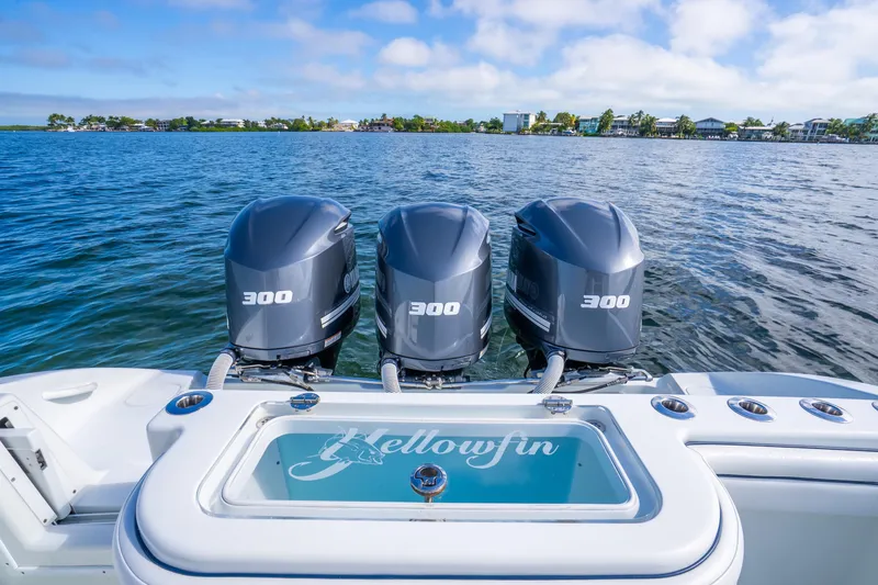 Slide: The Image of 2016 Yellowfin 36 Offshore boat with triple 300 horsepower engines on open water. - 33