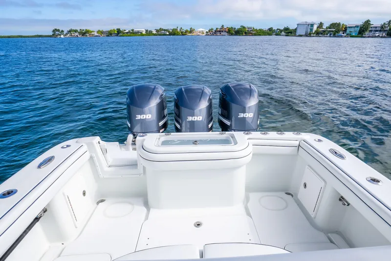 Slide: The Image of 2016 Yellowfin 36 Offshore boat with triple 300 horsepower engines on calm water. - 36