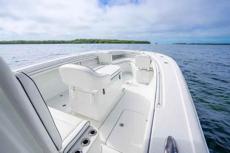 Slide: The Image of 2016 Yellowfin 36 Offshore boat on calm waters, featuring sleek white seating and open deck. - 38