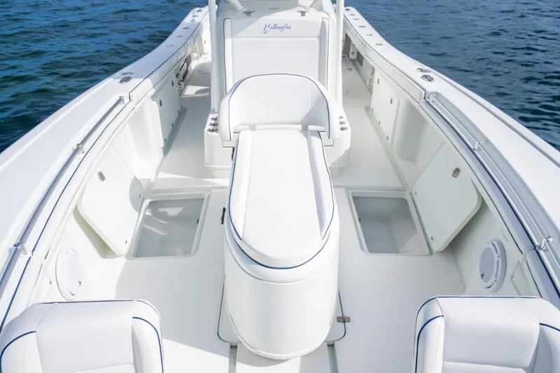 Slide: The Image of 2016 Yellowfin 36 Offshore boat interior with white seating and storage compartments. - 41