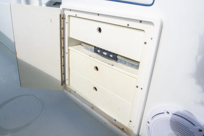 Slide: The Image of Open storage compartment on 2016 Yellowfin 36 Offshore boat, featuring three drawers. - 47