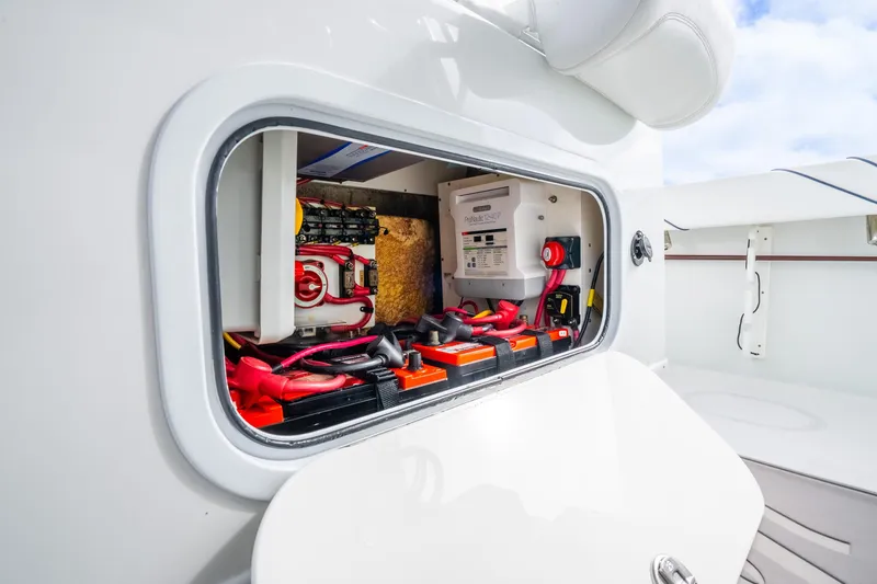 Slide: The Image of Electrical compartment of a 2016 Yellowfin 36 Offshore boat, showcasing wiring and components. - 52