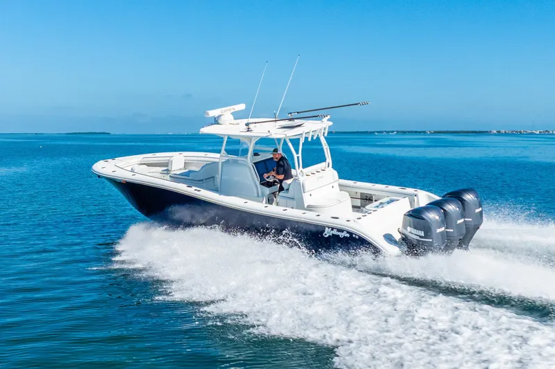 Slide: The Image of 2016 Yellowfin 36 Offshore boat cruising on clear blue water. - 7
