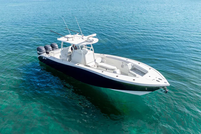 Slide: The Image of 2016 Yellowfin 36 Offshore boat on clear blue water, featuring triple outboard engines. - 9